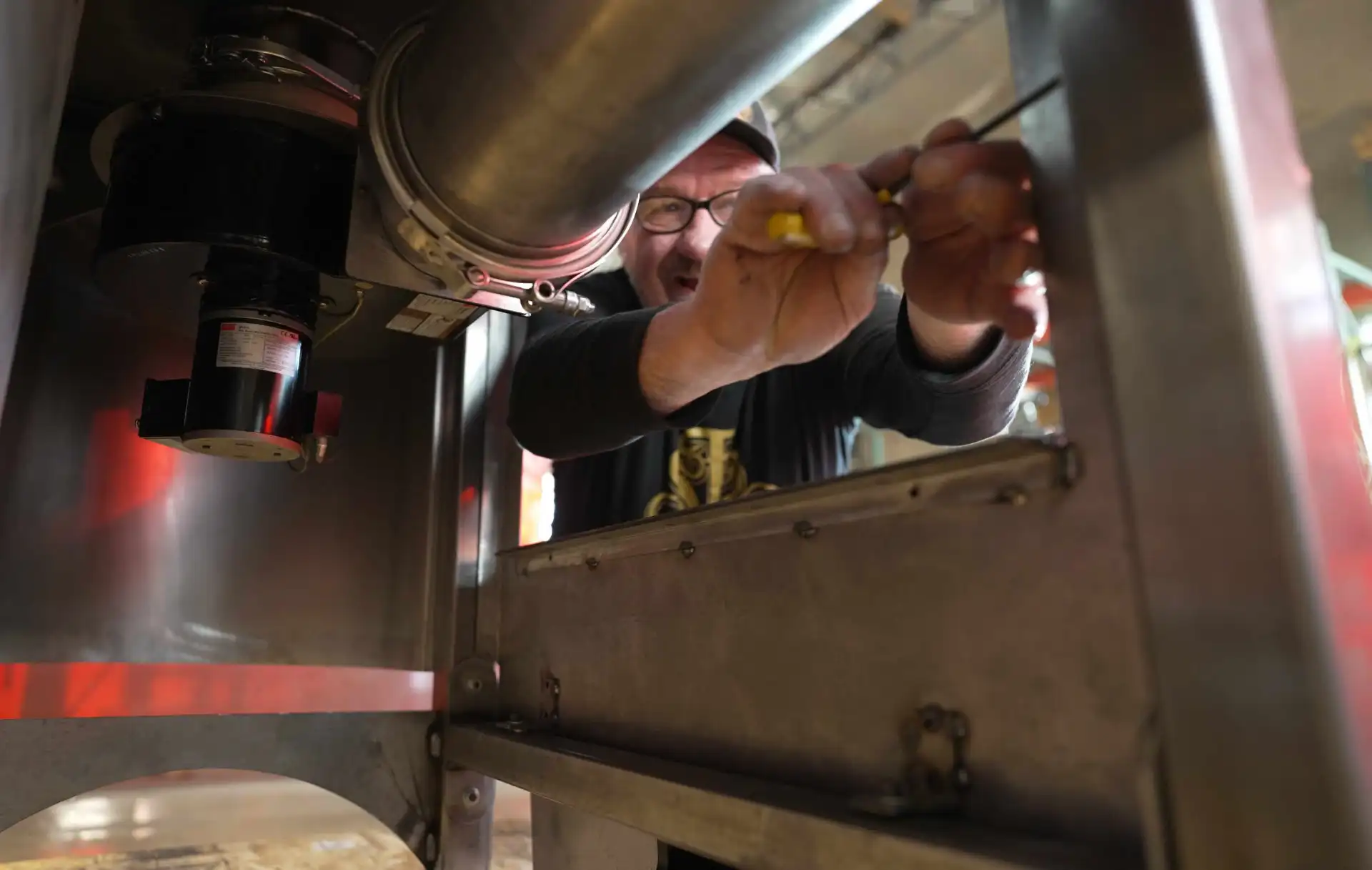 A craftsman at the San Franciscan Co. puts the finishing touches on a new coffee roaster